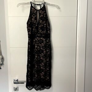 Black lace, lined, low back dress.